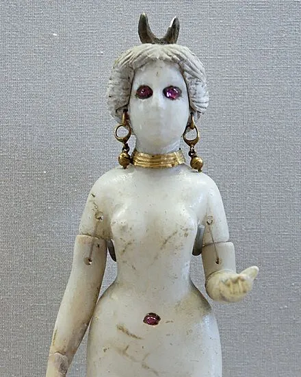 Alabaster statuette of Astarte with a crescent headdress and inlaid red eyes.