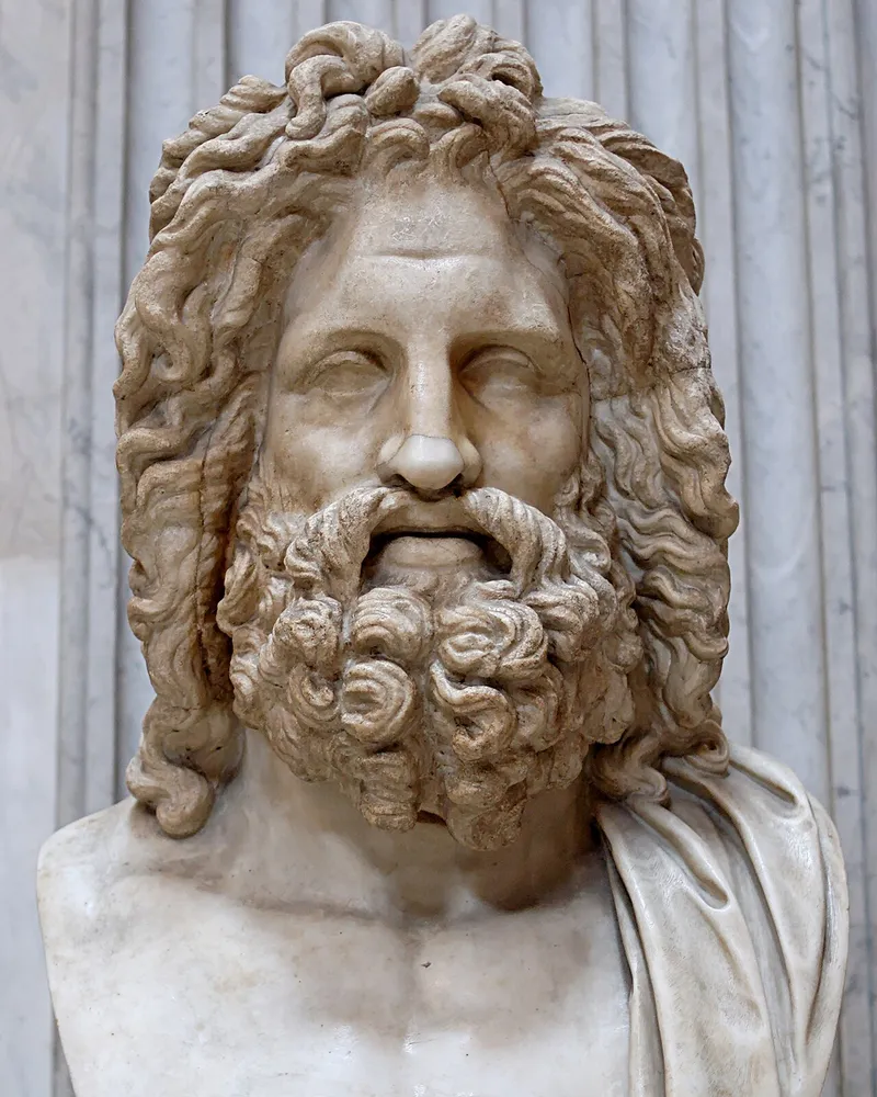 Marble bust of Zeus with flowing hair and a full beard.